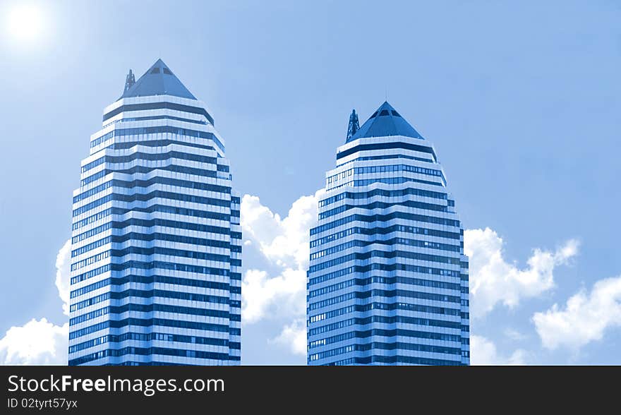 Two buildings  on a background of the blue sky. Two buildings  on a background of the blue sky