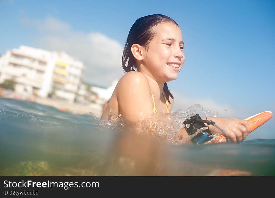 Girl surfing in the beach