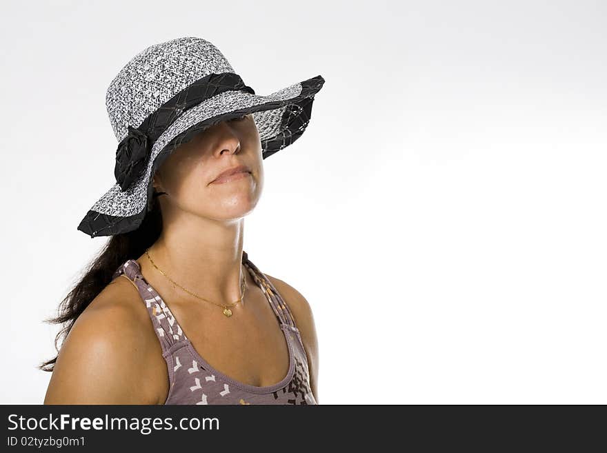 Fashion girl in a big hat in the studio. Fashion girl in a big hat in the studio