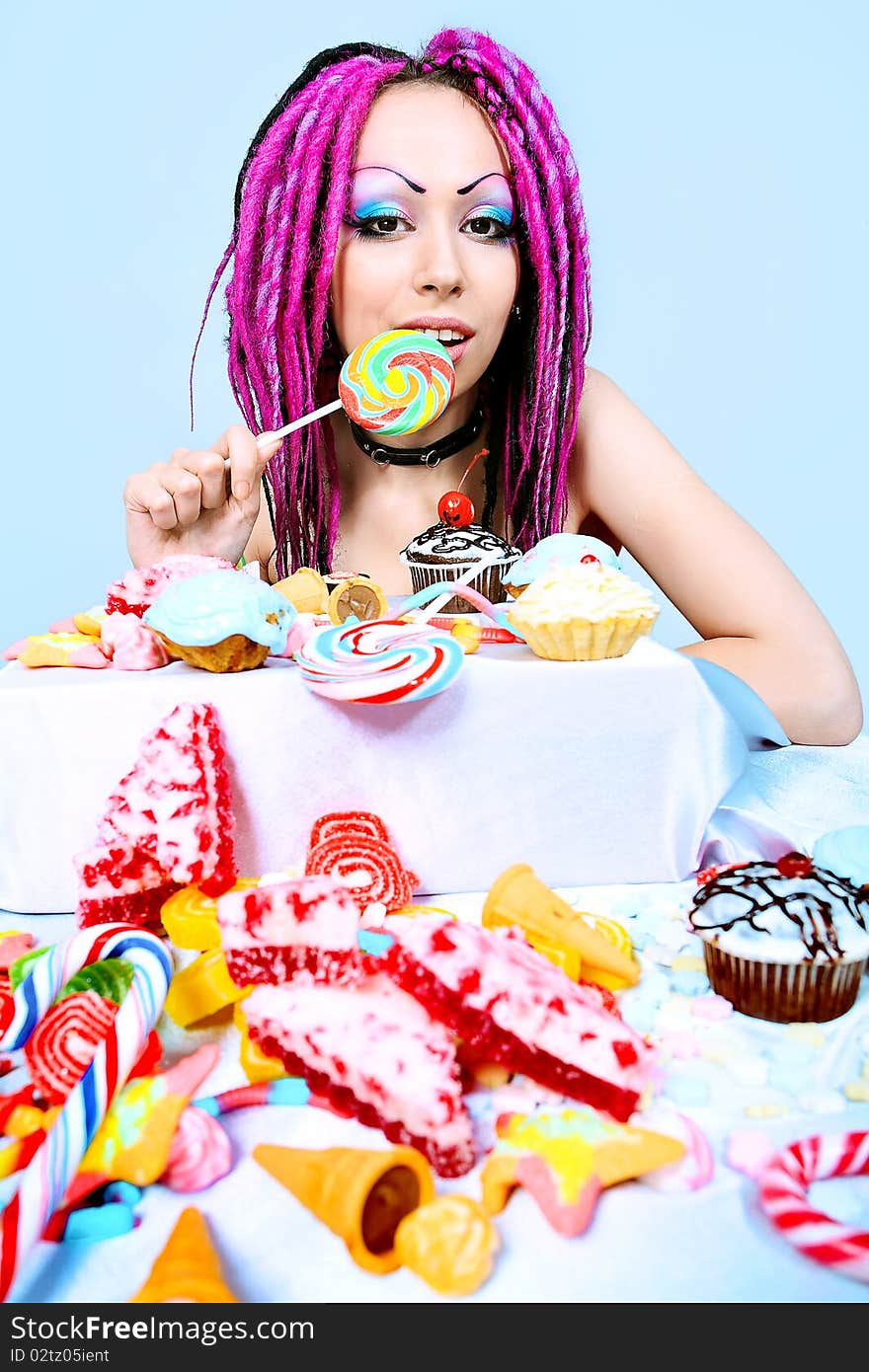 Portrait of a trendy girl with great number of sweets. Portrait of a trendy girl with great number of sweets.