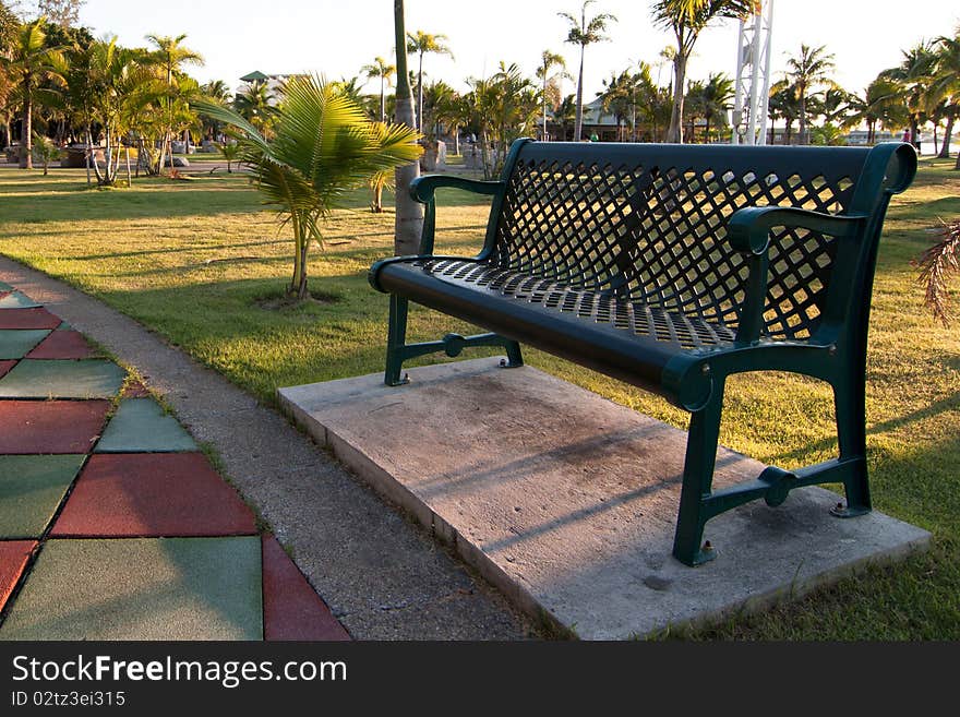 Bench in the garden on sunset