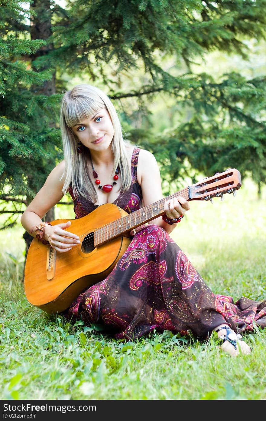 Girl plays the guitar, stringed instruments, smiling