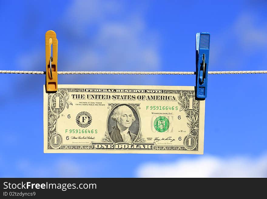 The American one dollar on a background of the sky