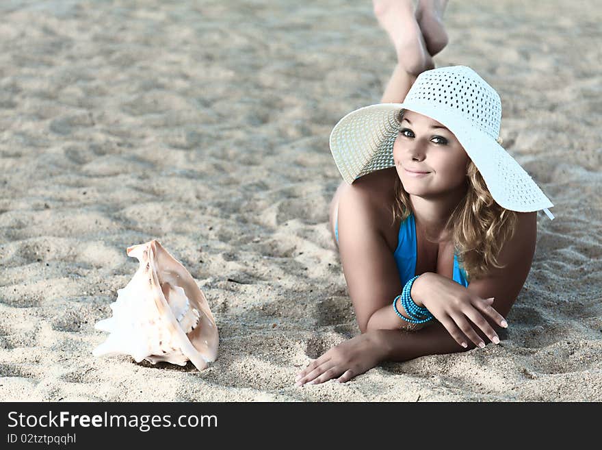 Young woman sunbathing on the tropical beach