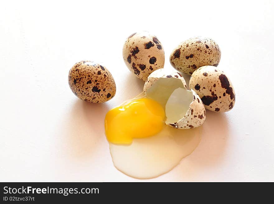 A few quail eggs and one broken. A few quail eggs and one broken