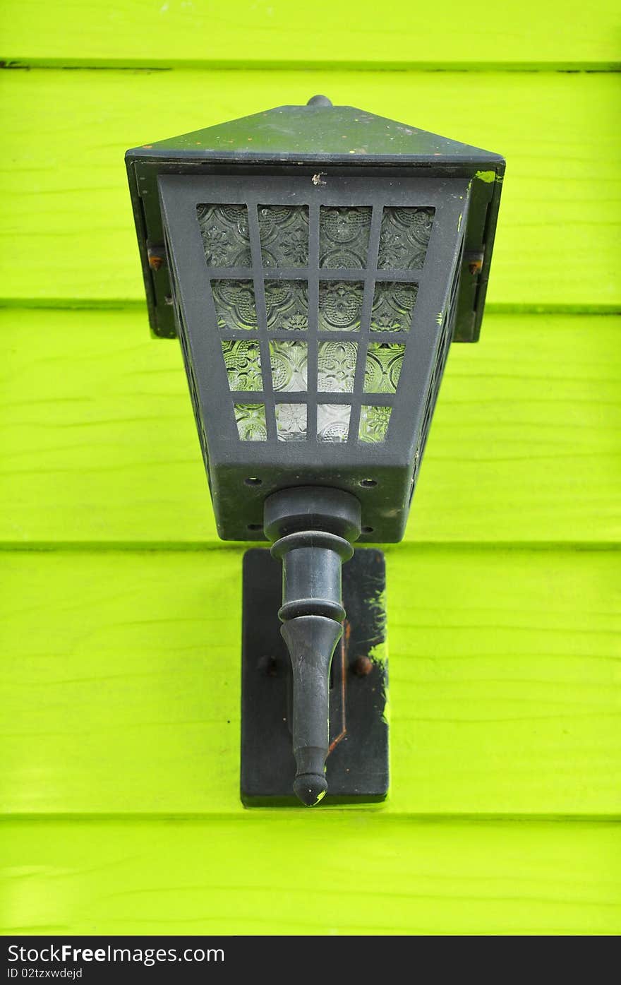 Street lamp on a textured wood wall