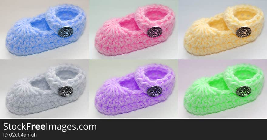 Six different colored baby booties with metallic lion button.