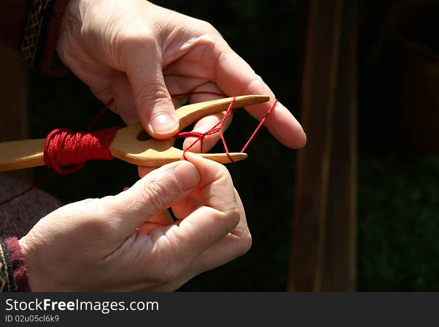 Medieval viking handicraft: cordmaking with a lucet.