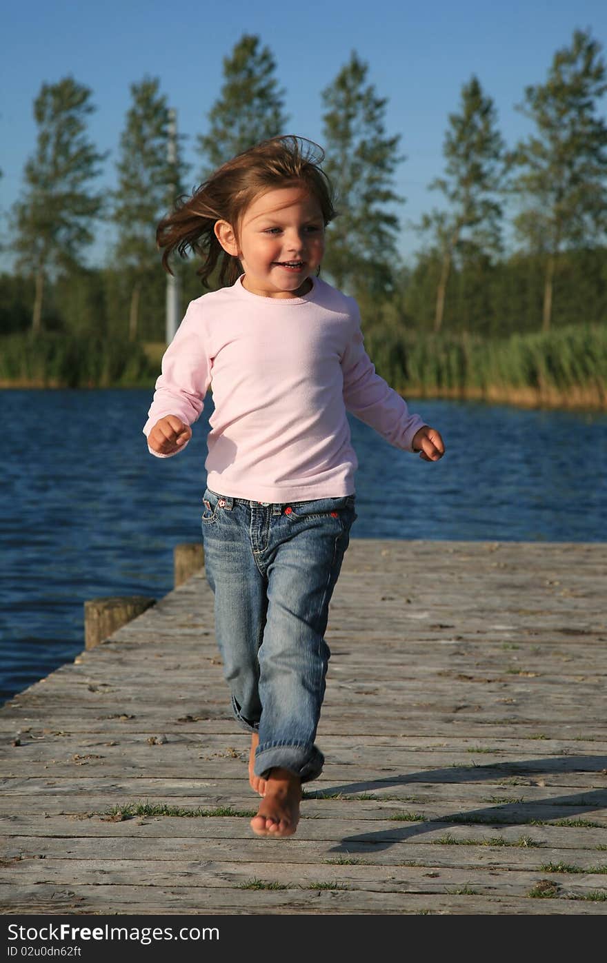 Young girl running on a ponton. Young girl running on a ponton