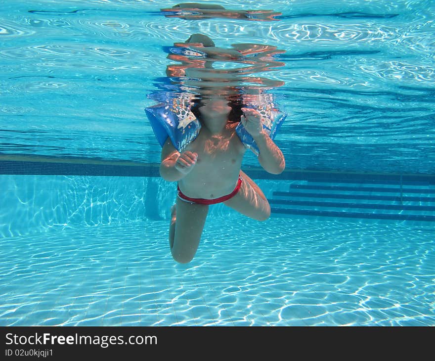 Swimming underwater photo of a child