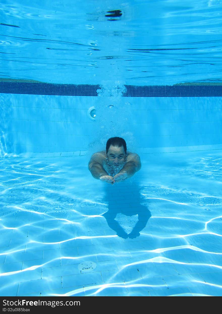 Swimming underwater photo of a men