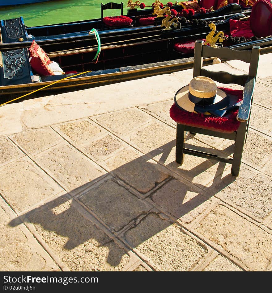 Gondola driver waiting chair under the sun proyecting shadow at Venice, Italy. Gondola driver waiting chair under the sun proyecting shadow at Venice, Italy