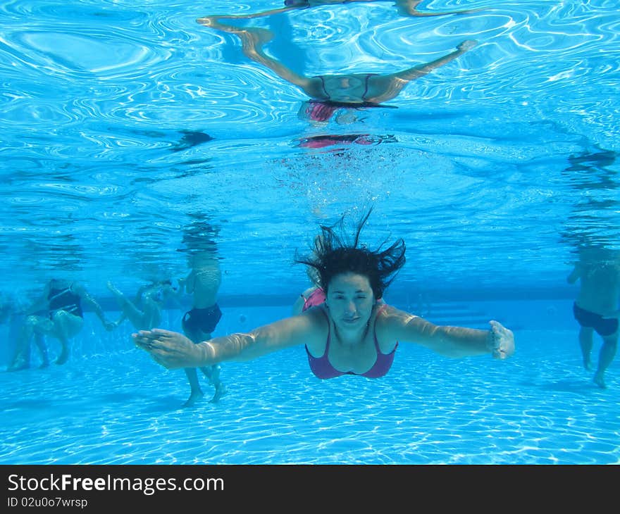 Woman swimming on a pool, underwater photo. Woman swimming on a pool, underwater photo