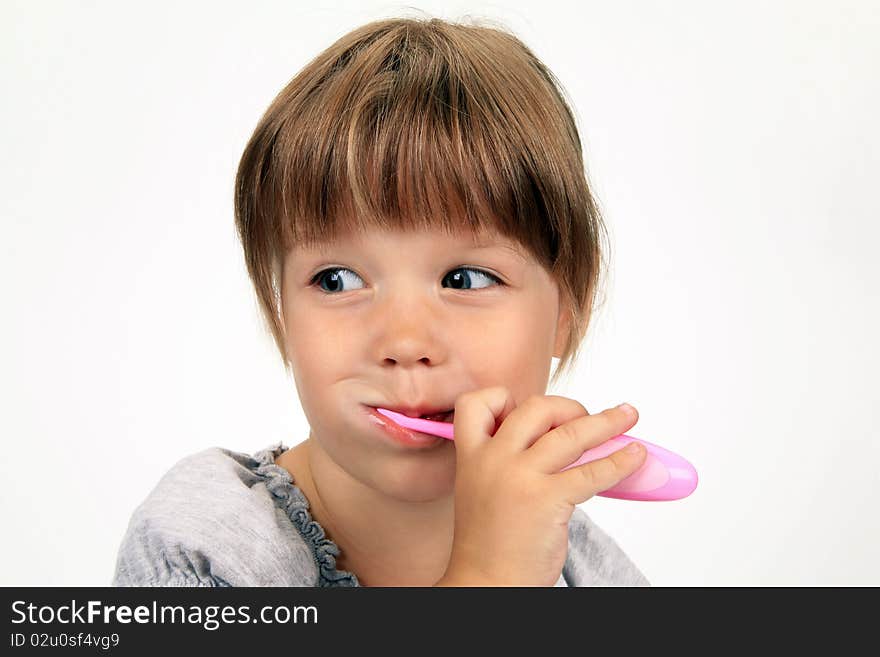 The smiling girl brushes teeth on a white background