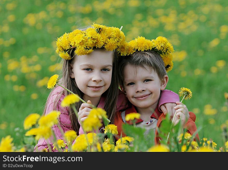 Brother and sister with dandelion garlands