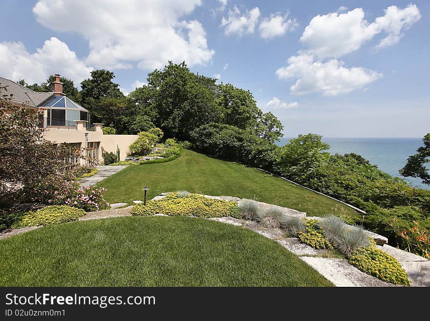 Rear view of luxury home with lake view