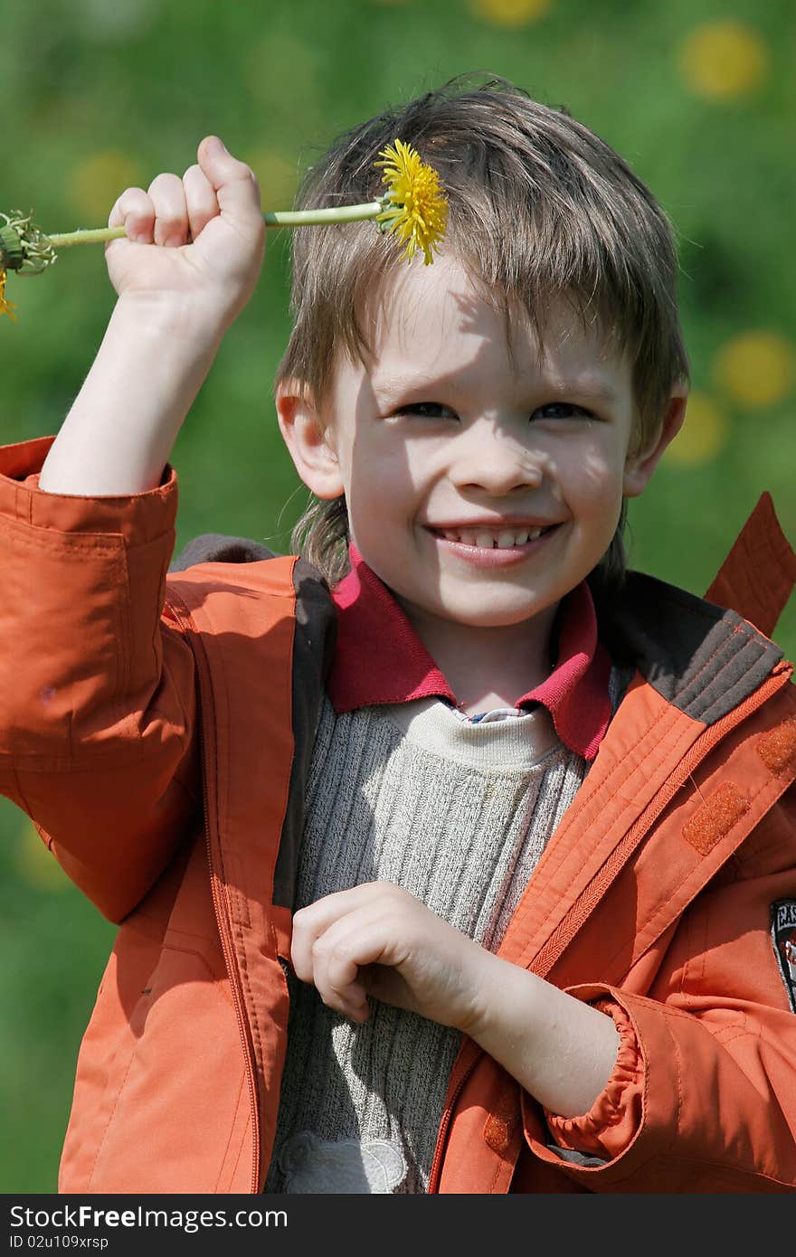 Young boy enjoy summer time in the dandelion meadow. Young boy enjoy summer time in the dandelion meadow.