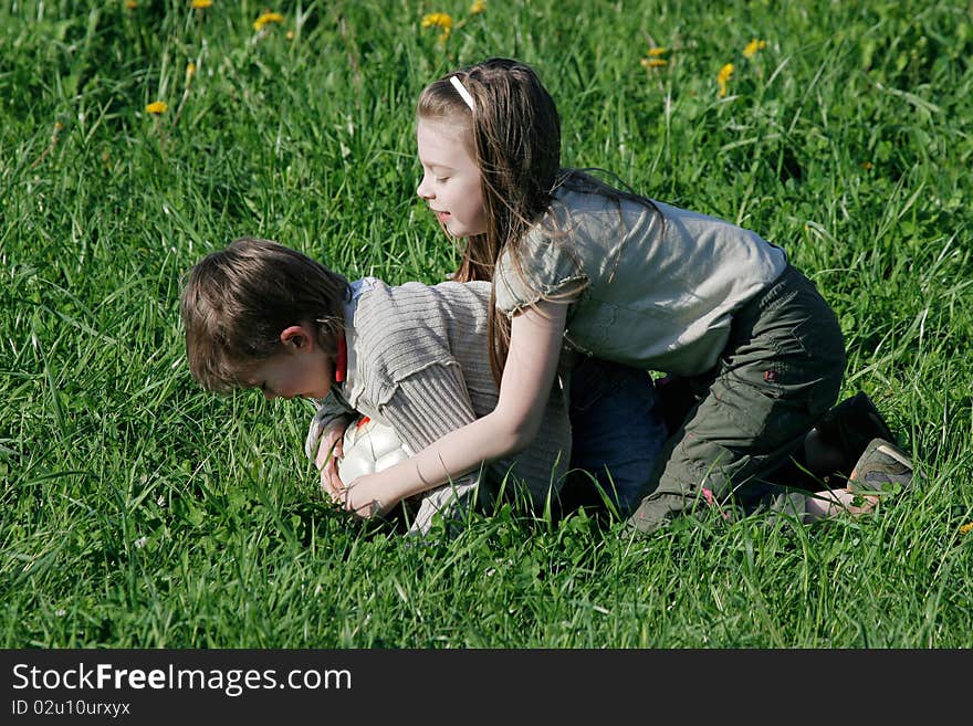 Brother and sister enjoy summer time in the green grass. Brother and sister enjoy summer time in the green grass.