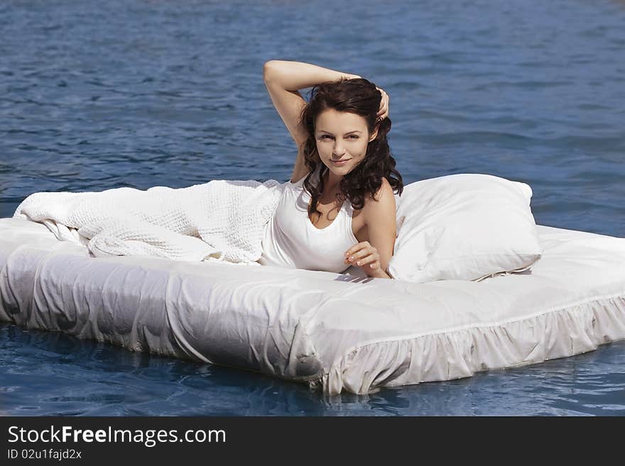 Woman lying on the bed in the sea