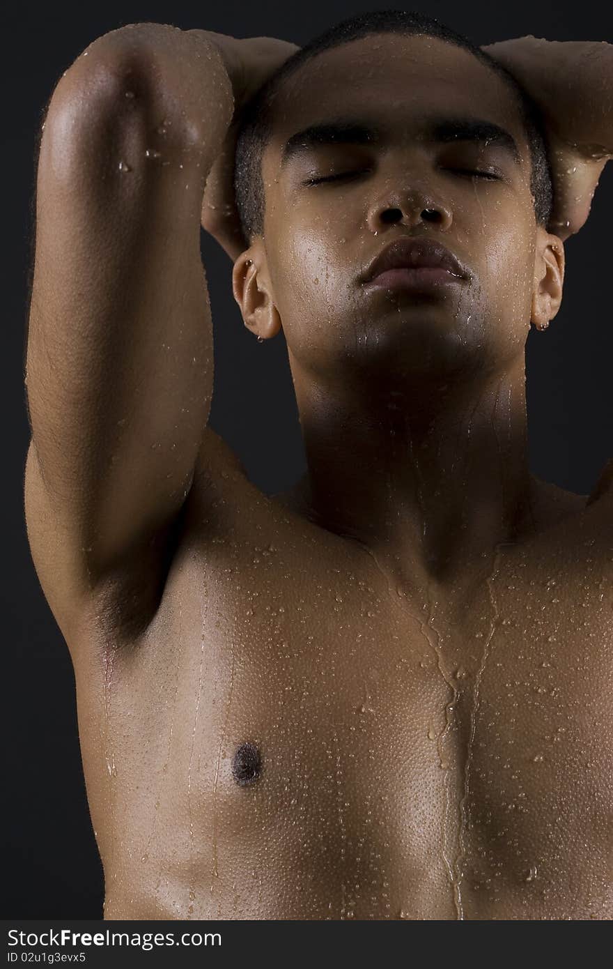 Drops of the water on naked body of a young man on black background. Drops of the water on naked body of a young man on black background.