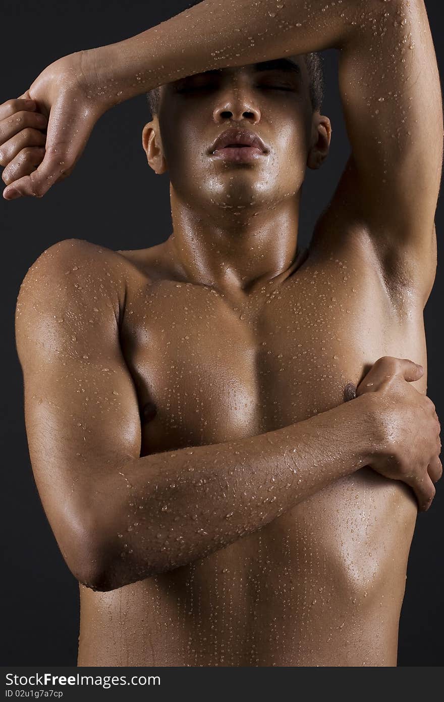 Drops of the water on naked body of a young man on black background. Drops of the water on naked body of a young man on black background.