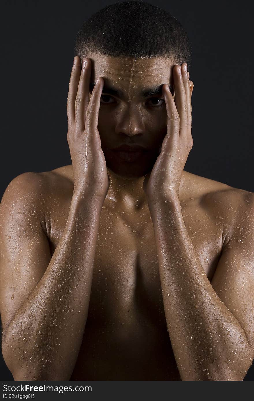 Drops of the water on naked body of a young man on black background. Drops of the water on naked body of a young man on black background.