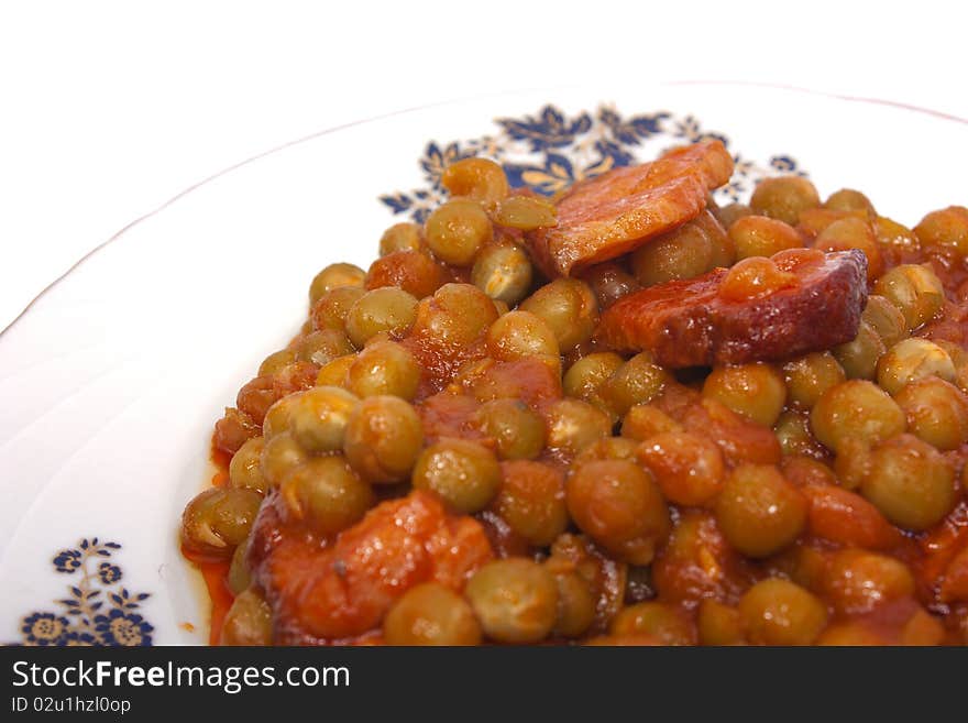 Cooked peas with bacon and carrots isolated on white background with clipping path. Cooked peas with bacon and carrots isolated on white background with clipping path