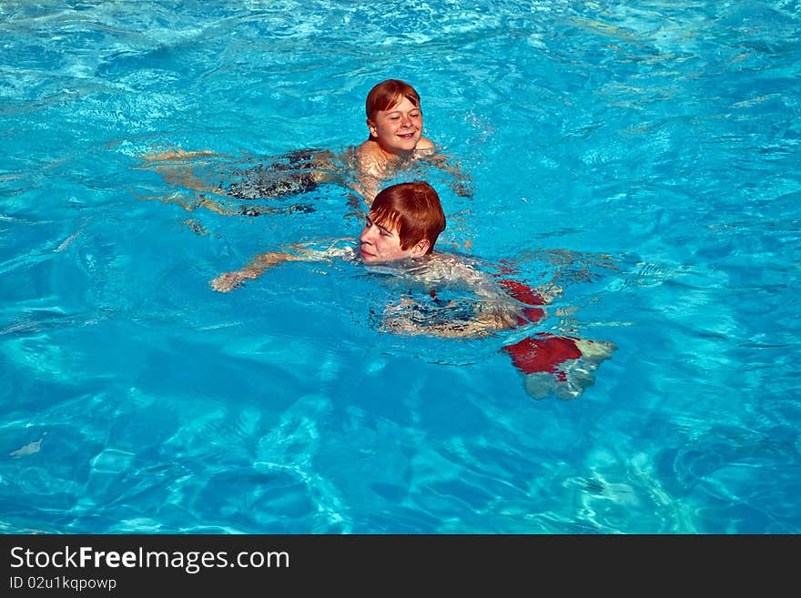 Two brothers having fun in the pool. Two brothers having fun in the pool