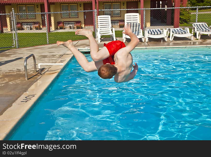 Child has fun jumping in the pool. Child has fun jumping in the pool