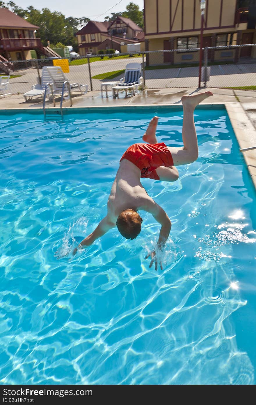 Child has fun jumping in the pool. Child has fun jumping in the pool