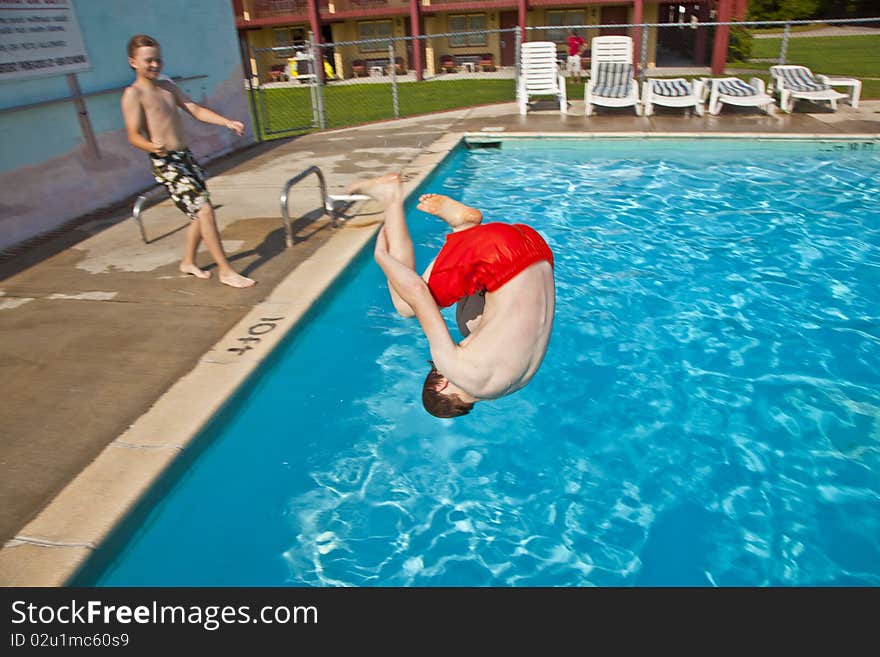 Child has fun jumping in the pool. Child has fun jumping in the pool