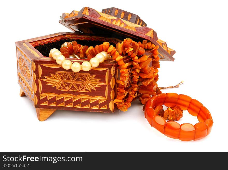 The wooden casket and amber isolated on white background