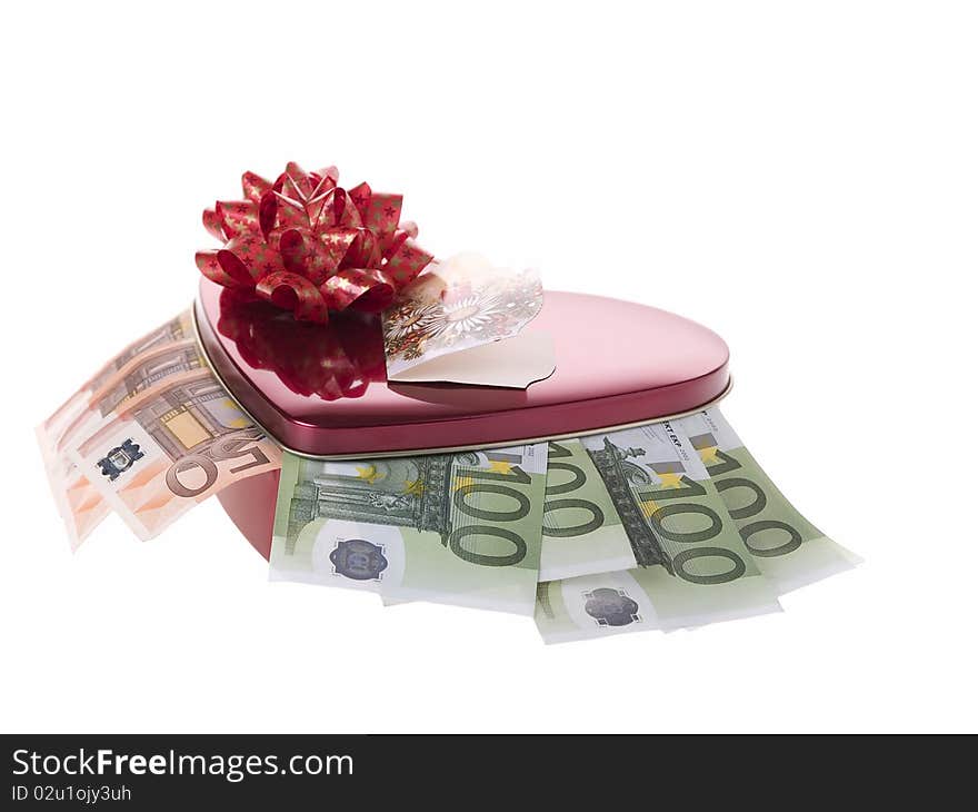 The photo shows some banknotes and a container in form of a heart over white