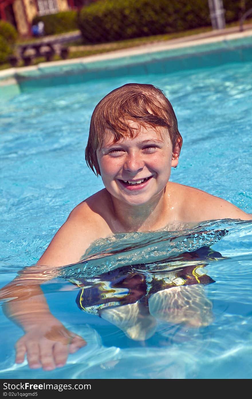 Laughing child has fun in the pool