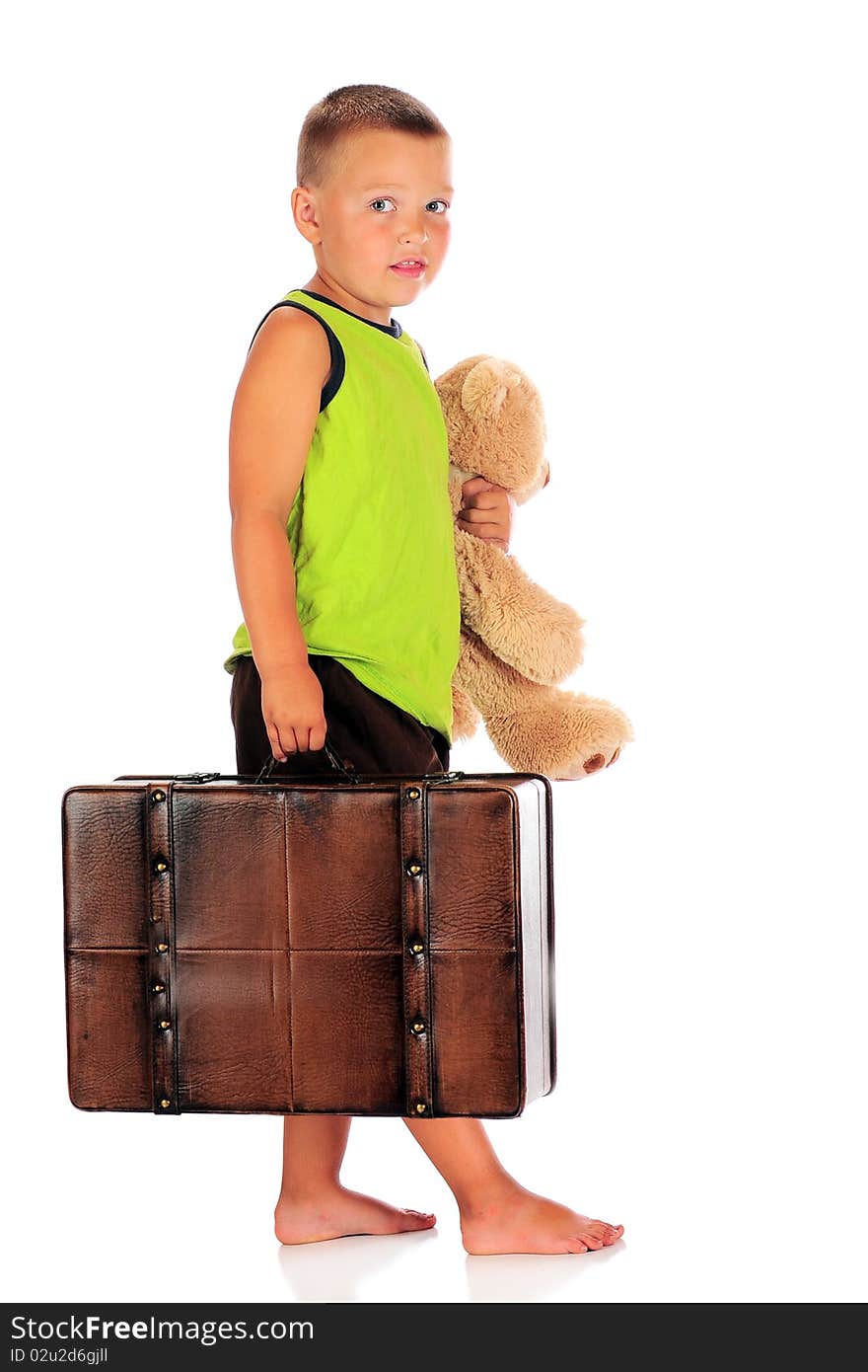 A barefoot preschool boy ready for an overnight away from home.  Isolated on white. A barefoot preschool boy ready for an overnight away from home.  Isolated on white.