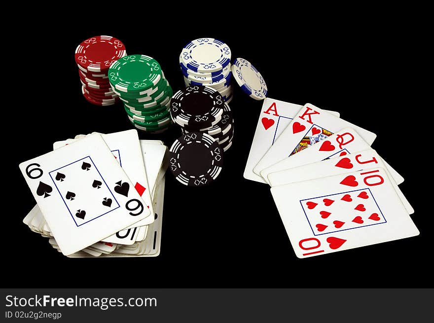 Royal Flush Card Hand with Poker Chips Isolated on black. Royal Flush Card Hand with Poker Chips Isolated on black