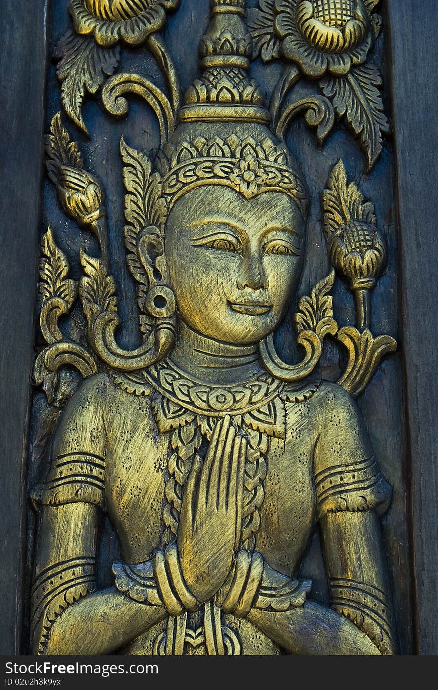 Buddha carved gold paint on thai church door