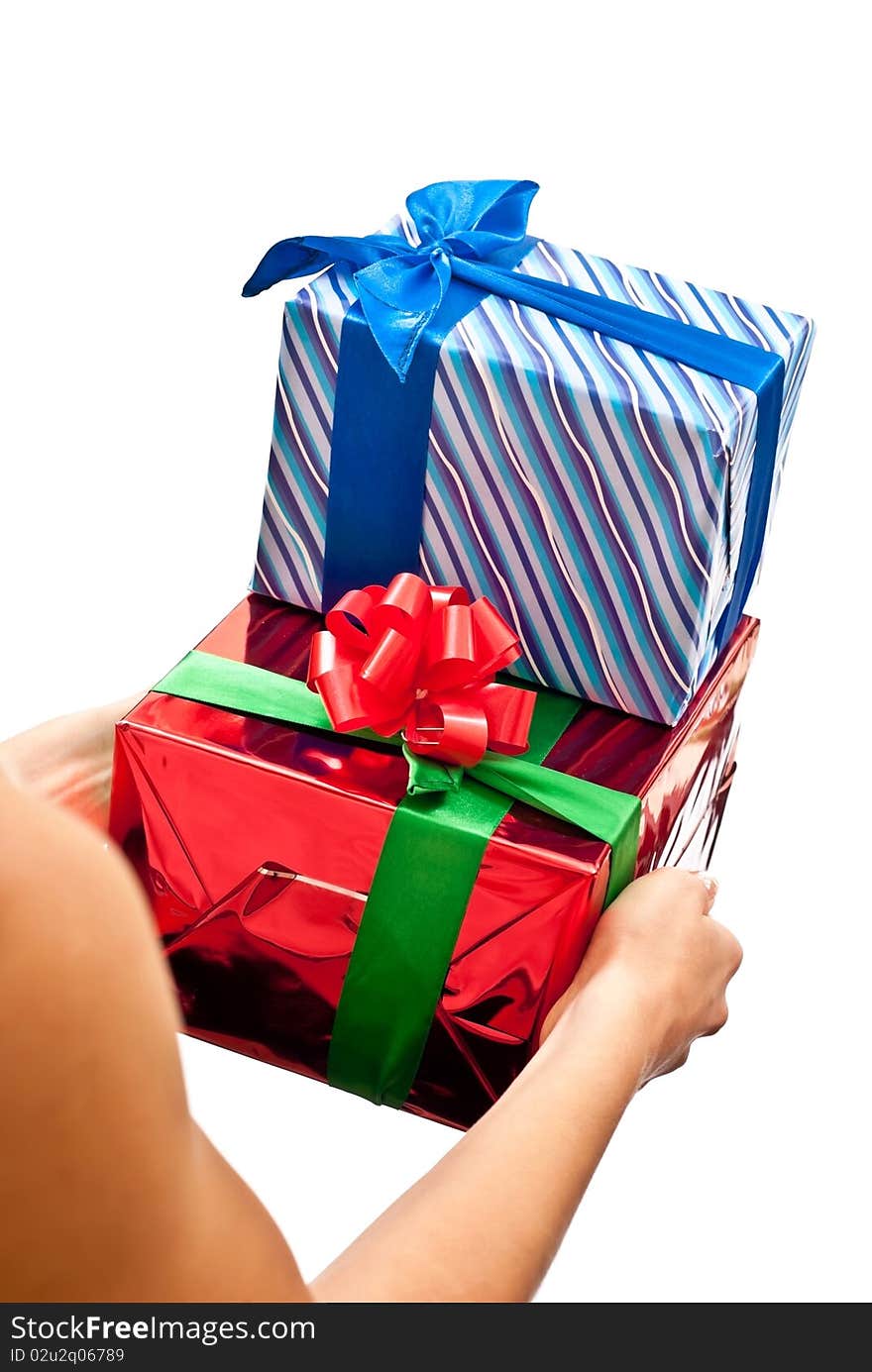 Woman's hands with a red and blue gifts boxes isolated on white background