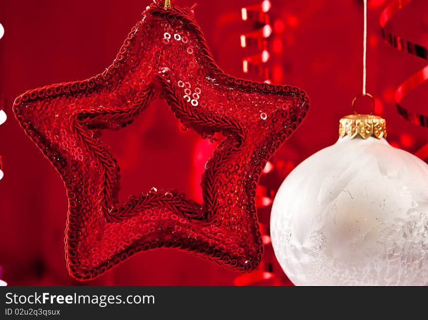 Beautiful christmas star and white baubles on red background