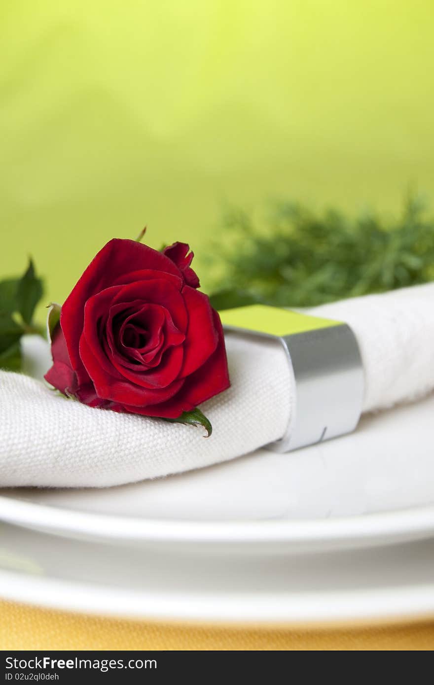 Red rose and white napkin. Red rose and white napkin