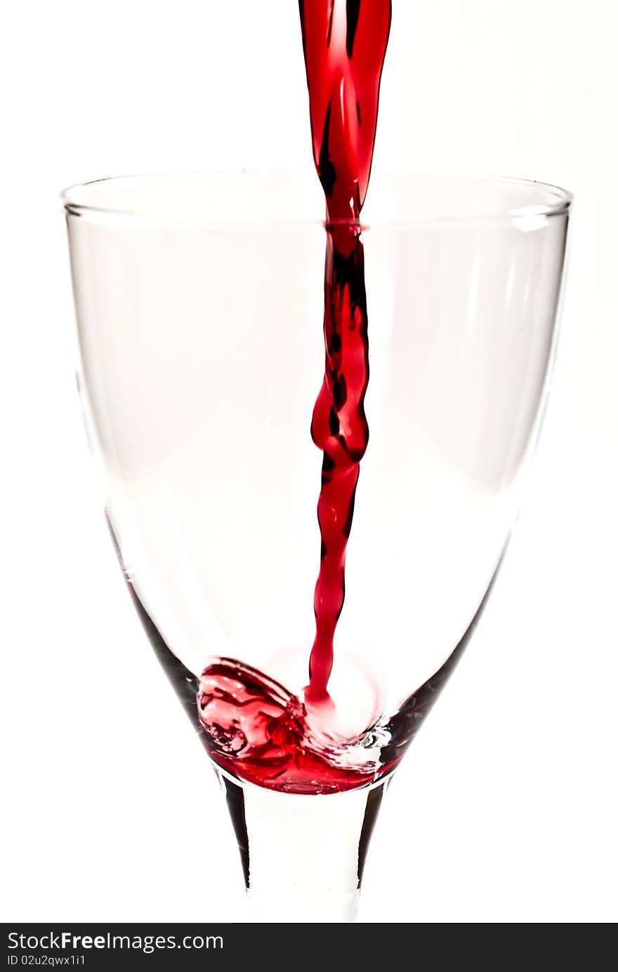 Red wine is flowing into the wine glass V1