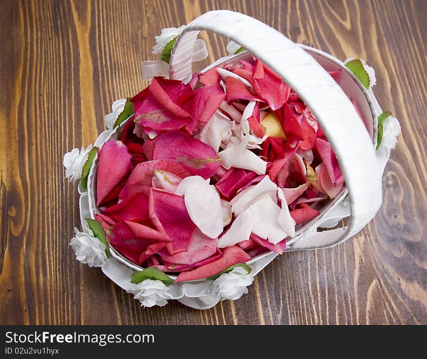 White basket with red rose petals