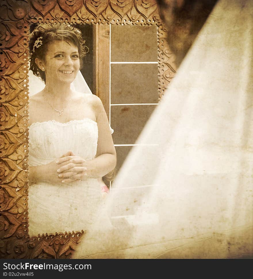 Vintage photo of bride looking into mirror