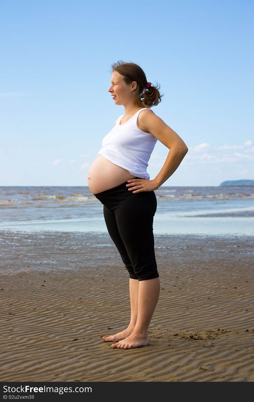 A pregnant girl on the shore of the White Sea.