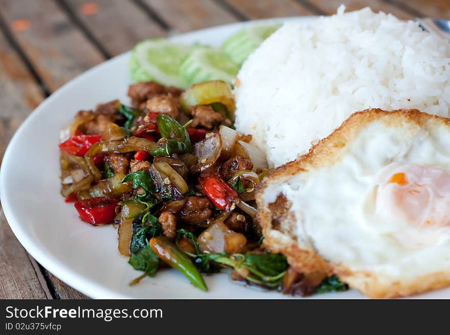 Rice topped with stir-fried pork and basil with fried egg. Rice topped with stir-fried pork and basil with fried egg