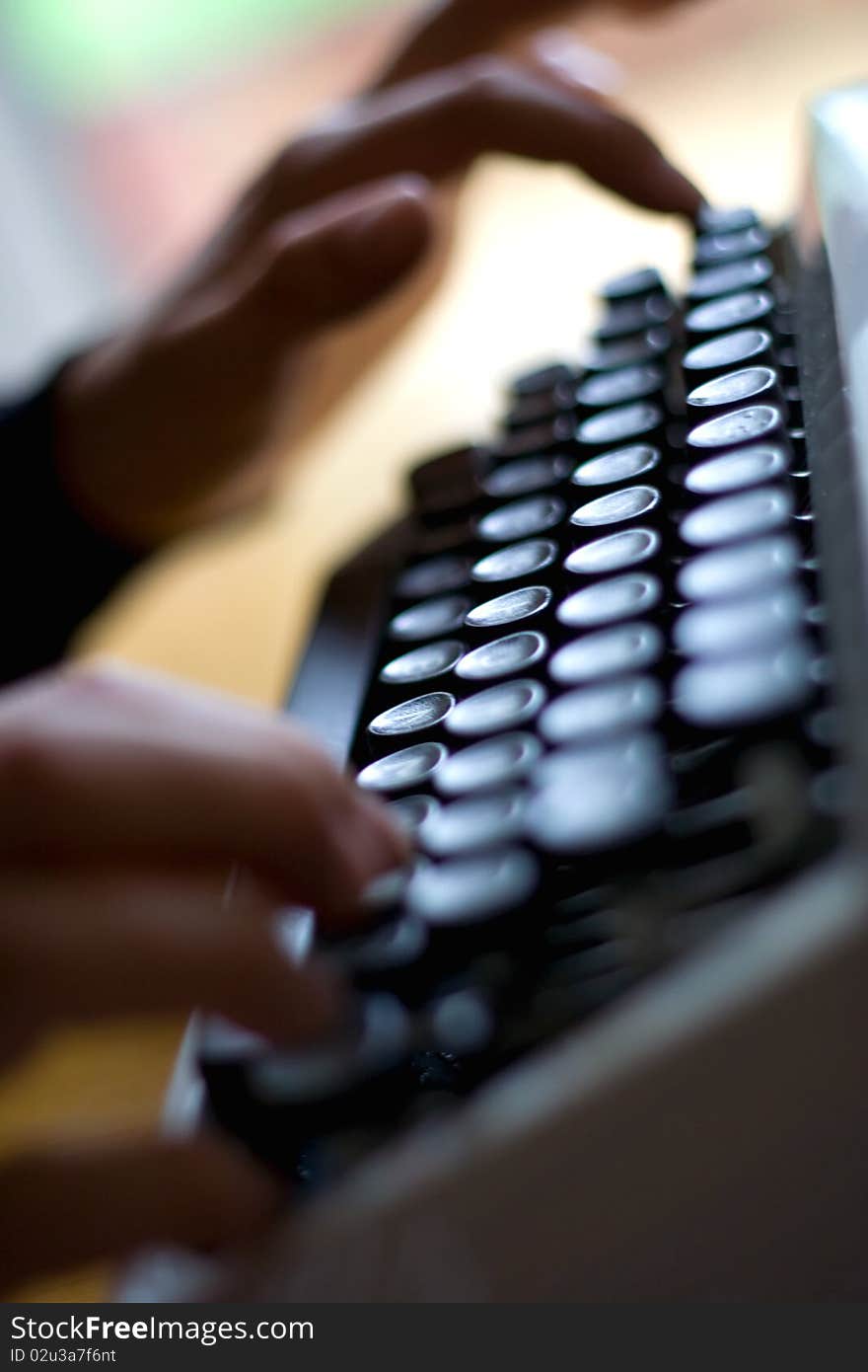 Index finger pressing down on a typewriter key. Index finger pressing down on a typewriter key.