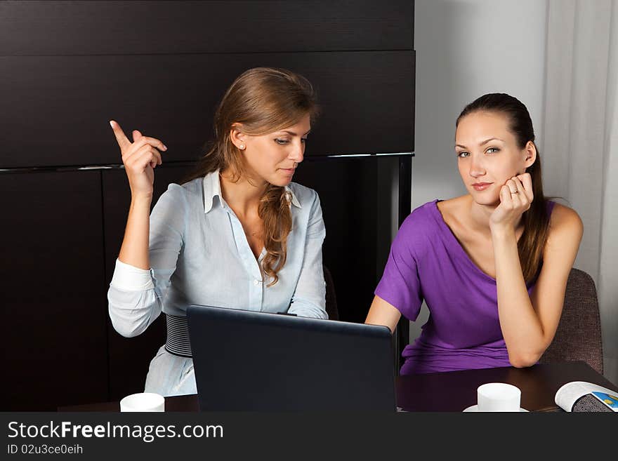 Two Young Women While A Coffee Break