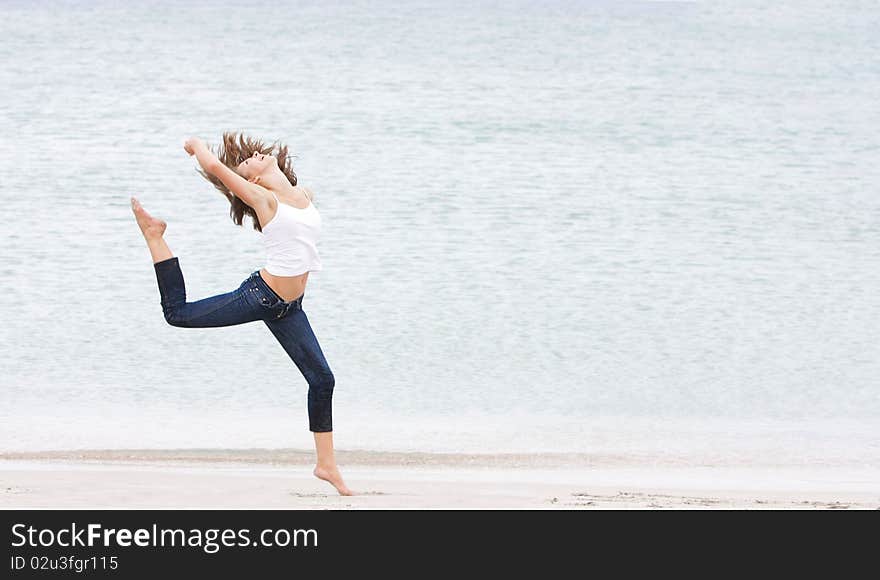 Young girl doing gymnastics on beach