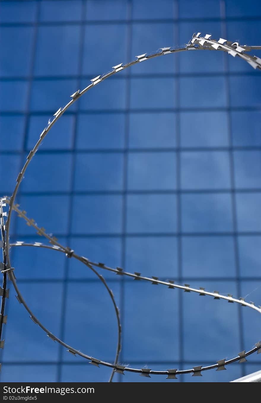 Barbed Wire On A Background Of Office Building