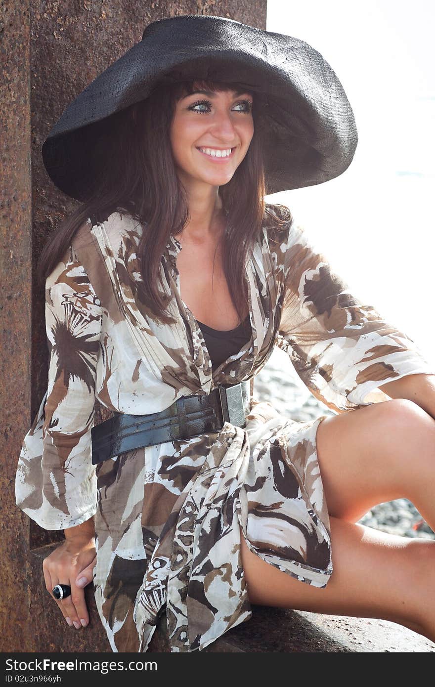 Young female wearing summer dress and hat, brightly backlit. Young female wearing summer dress and hat, brightly backlit.